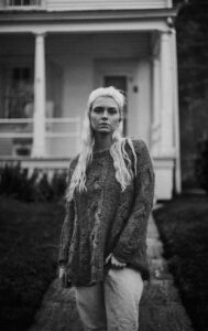 Cinematic black and white classroom portrait with strong shadows and film-style composition